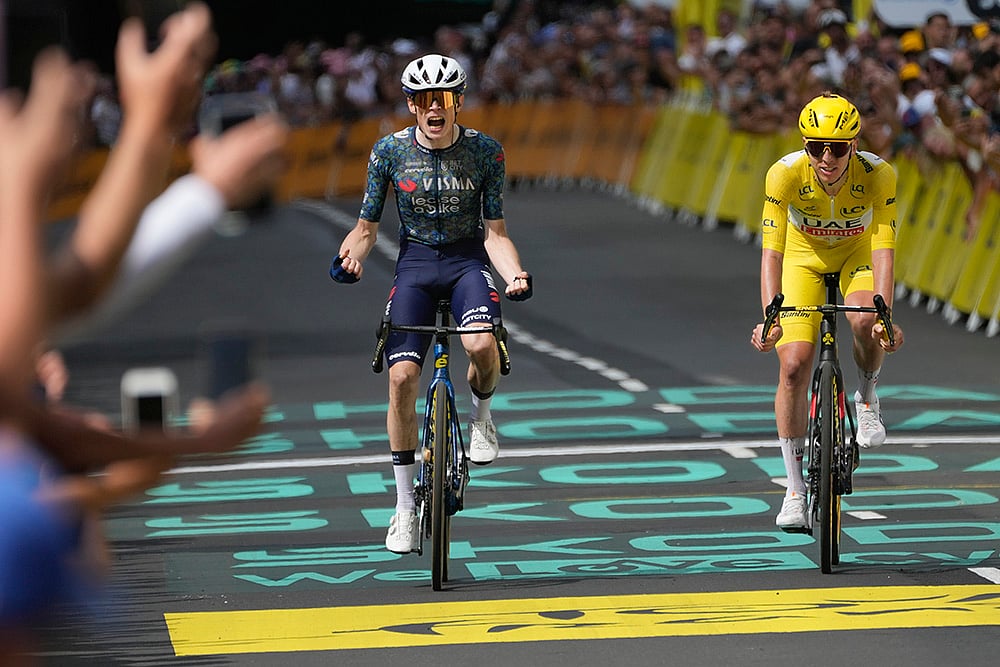 | Photo: AP/Jerome Delay : Jonas Vingegaard celebrates as he crosses the finish line ahead of Tadej Pogacar